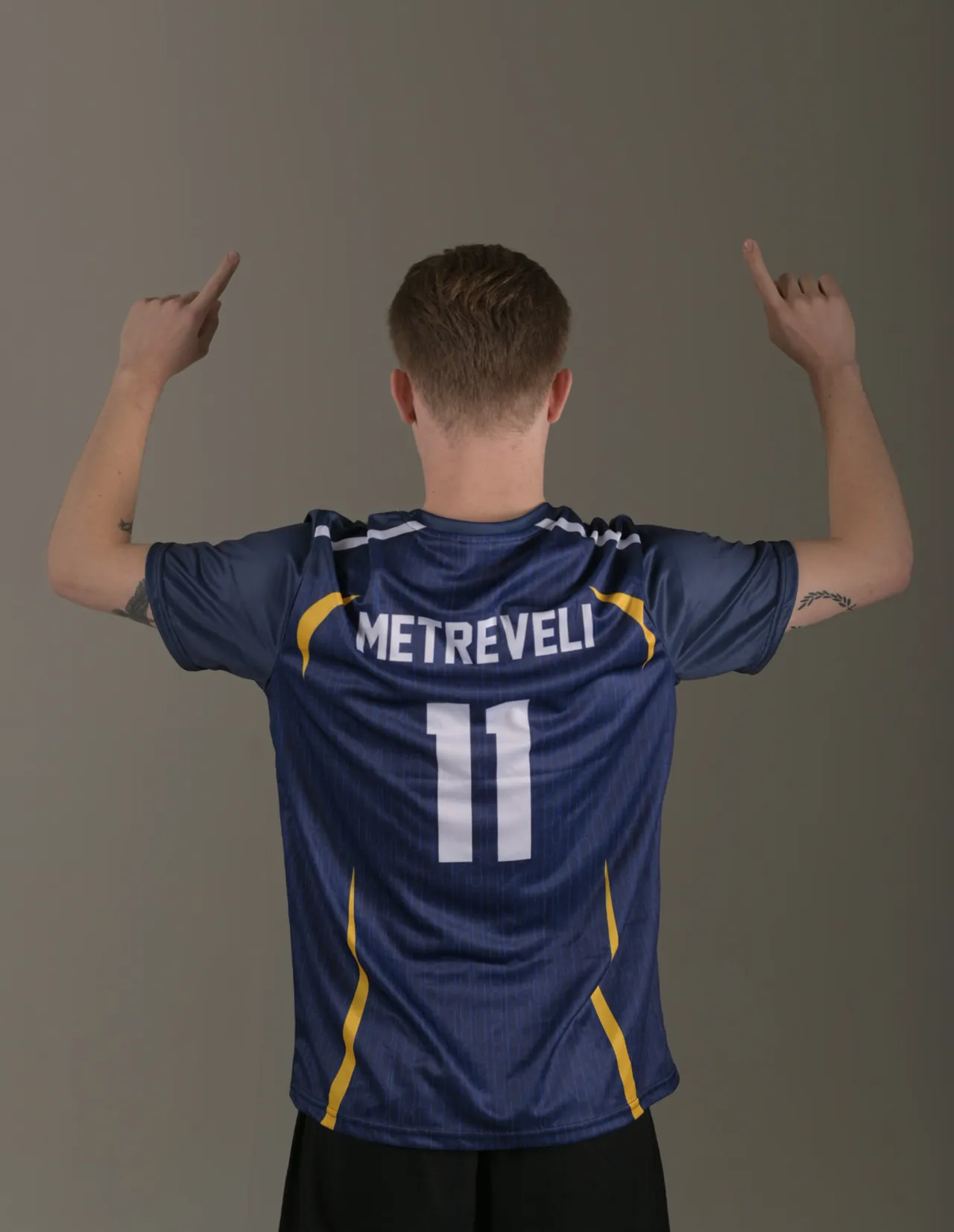 Back view of a navy custom football jersey with Metreveli 11 printing — sportswear photography for a team kit brand