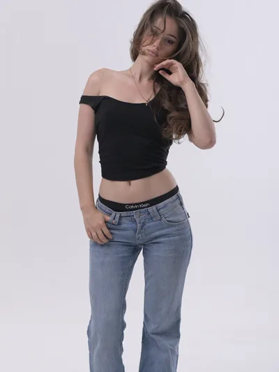 Tako modeling a black off-shoulder top and jeans in a Tbilisi photo studio