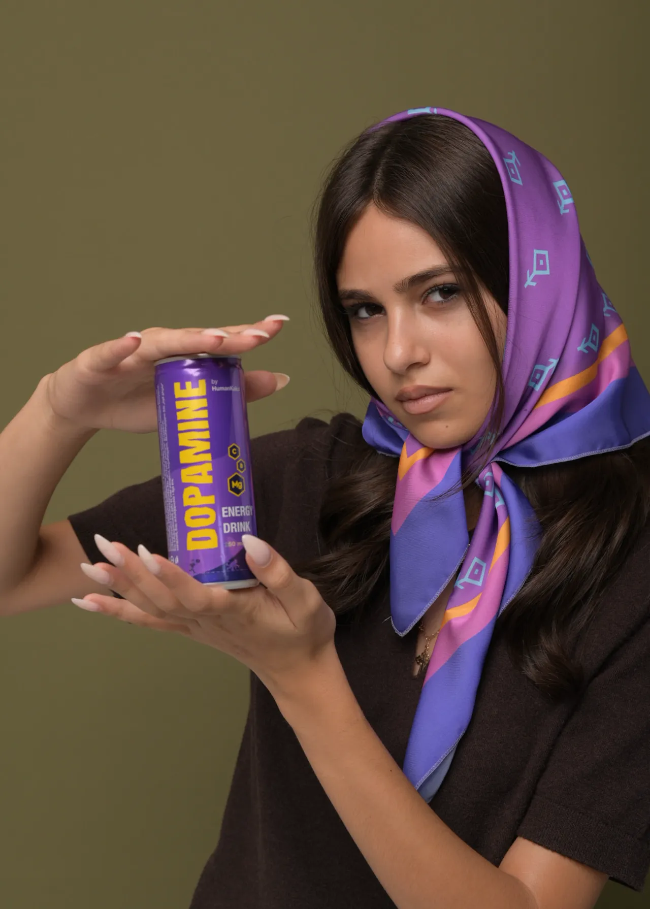 Model holding a purple Dopamine energy drink can — commercial beverage campaign photo with a model in Tbilisi