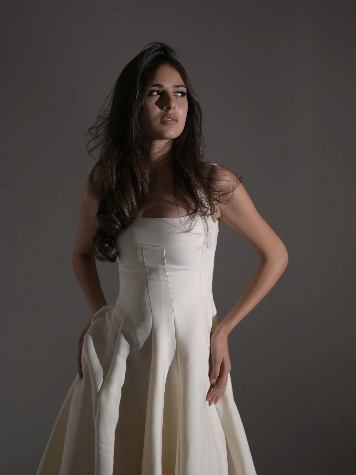 Editorial studio portrait of Anano wearing an elegant white dress