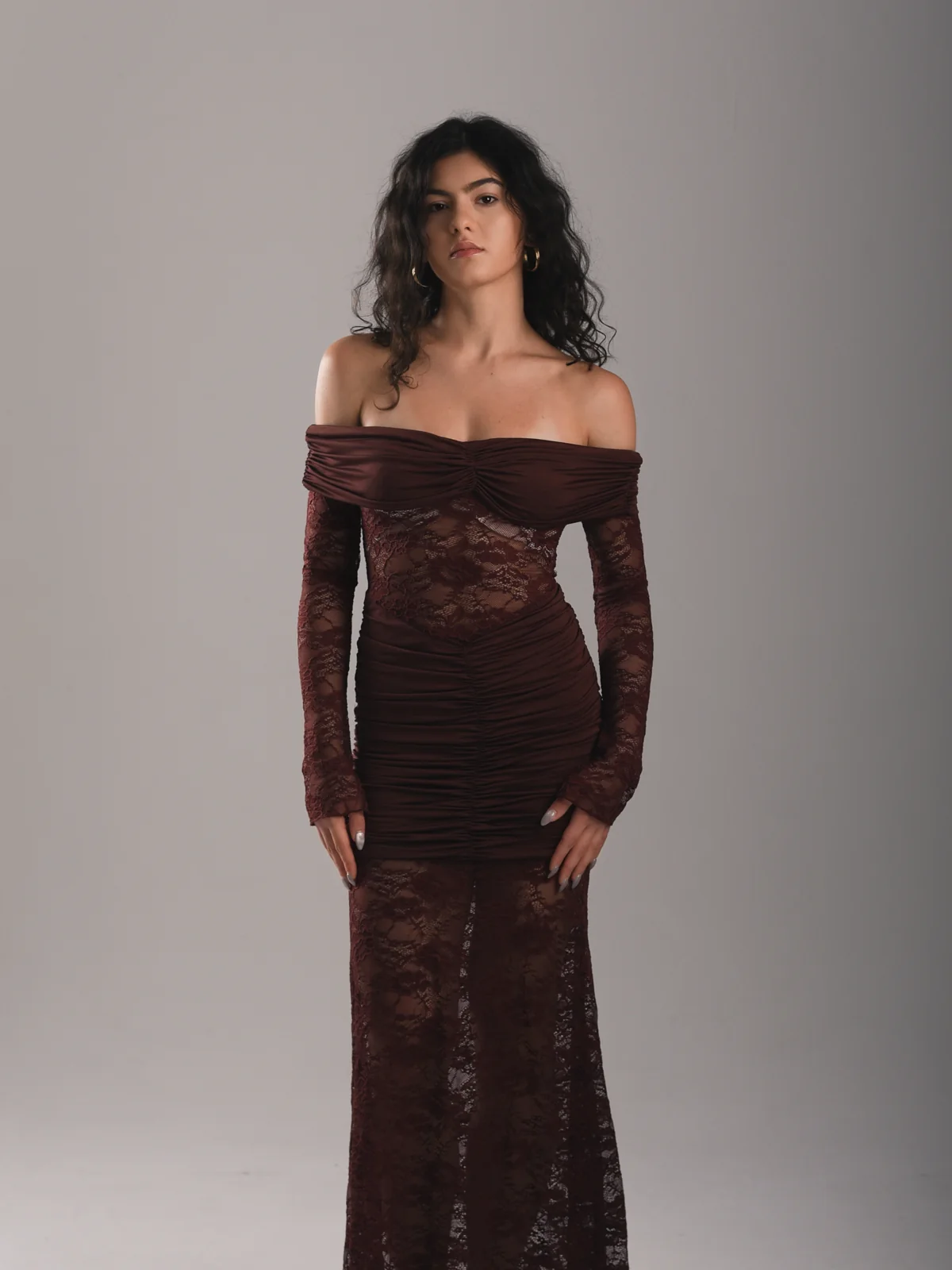 Front-facing fashion portrait of Mariami wearing an off-shoulder burgundy dress