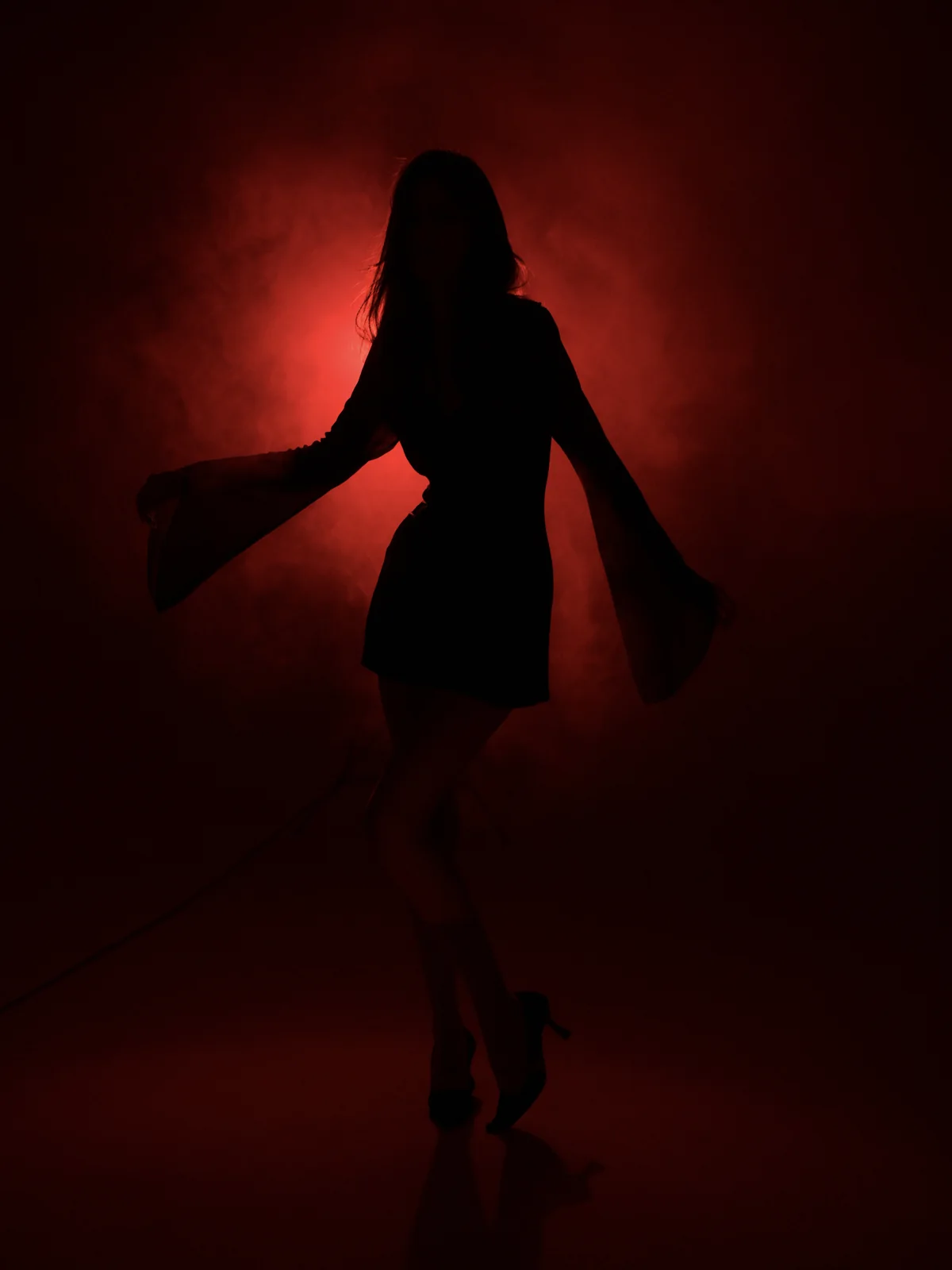 Dramatic red-light silhouette of Anano during an editorial studio shoot