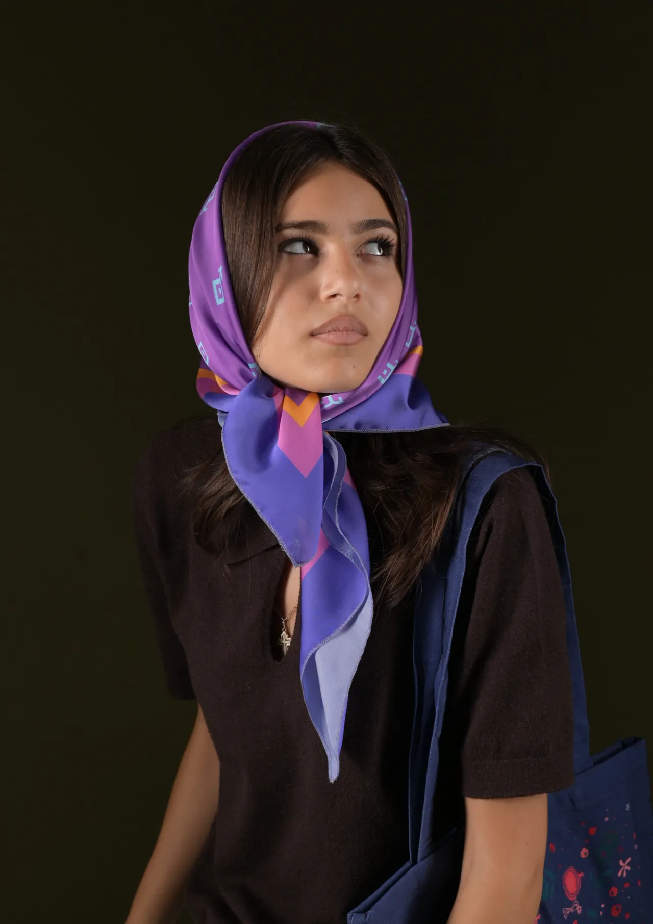 Model wearing a purple silk headscarf and a navy tote bag — accessories campaign photography in a Tbilisi studio