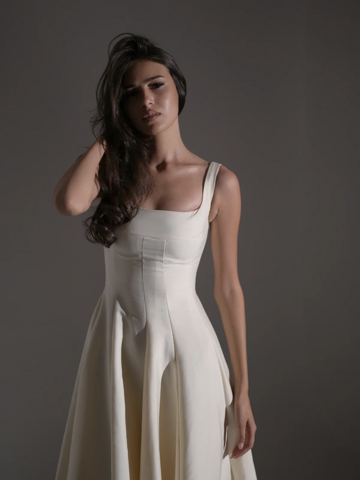 Anano posing in a white dress for an editorial photoshoot in Tbilisi